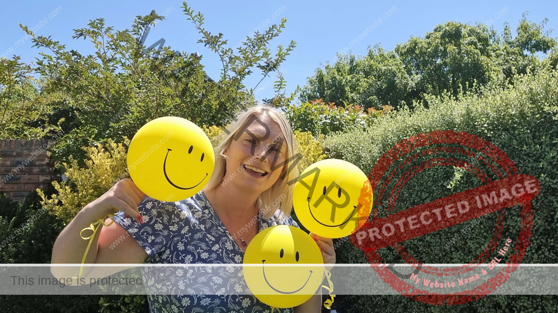 Diana Fels holding 3 smiley faces balloons Diana Fels holding 3 smiley faces balloons